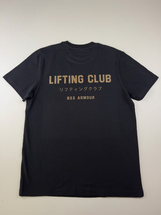 A black short-sleeve t-shirt shown from the back, featuring 'LIFTING CLUB' in distressed gold lettering with Japanese characters and 'BOX ARMOUR' printed below, laid flat against a light off-white background.